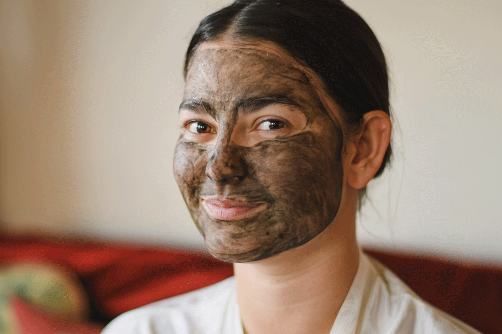 Lady smiling with Charcoal Clay mask by Source Vitál Apothecary