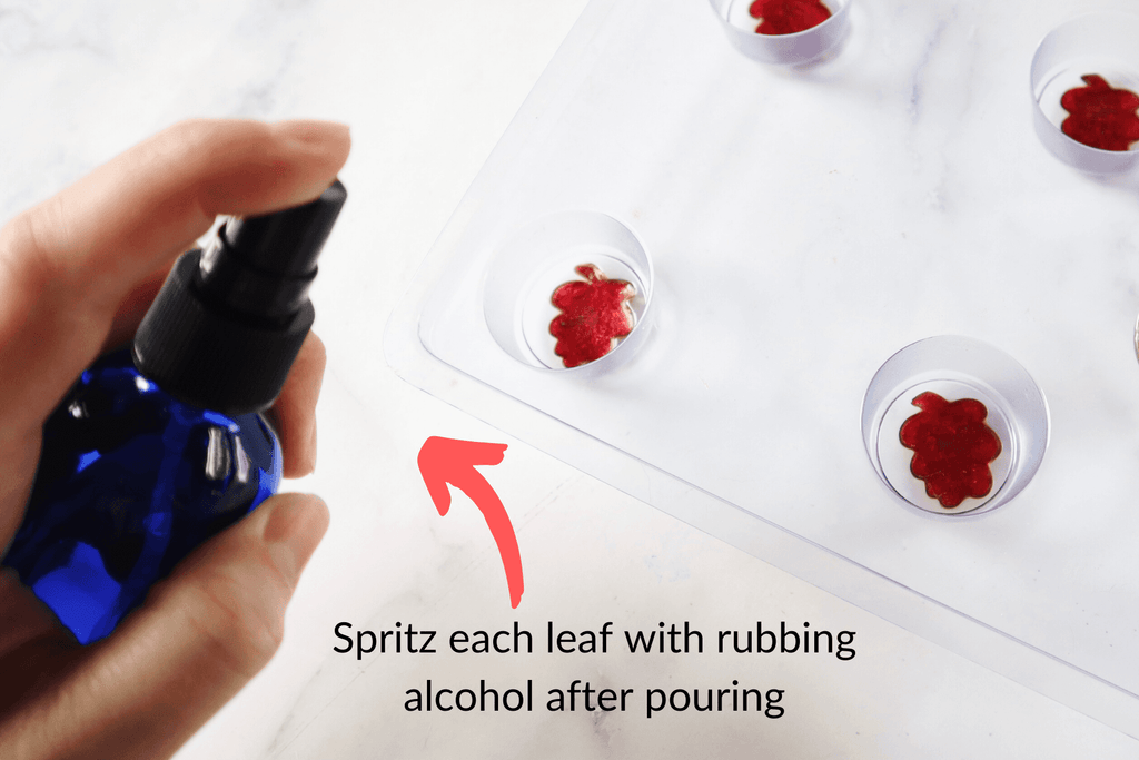 spraying soap with rubbing alcohol to remove bubbles