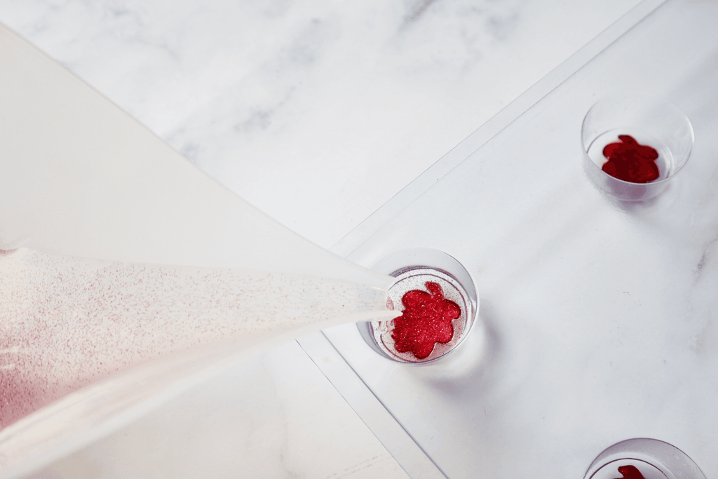 pouring glittery soap base into soap mold