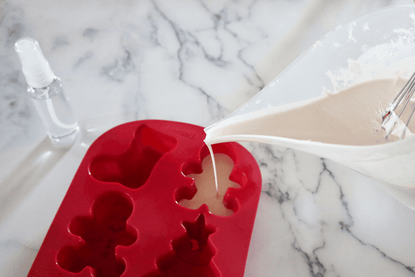 pouring soap base into a silicone soap mold