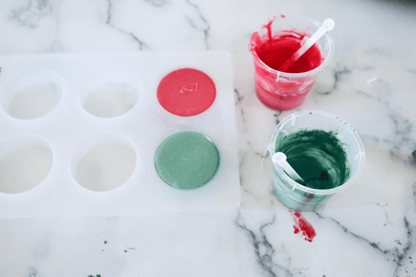red and green soap that has been poured into a silicone soap mold