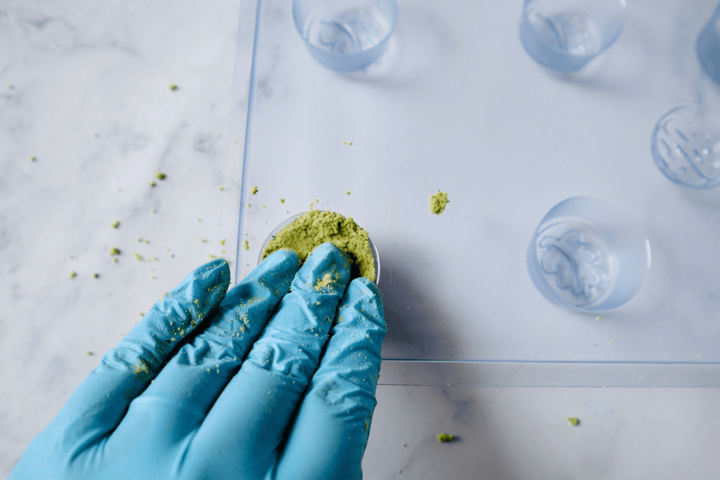 pressing bath bomb mixture into a mold