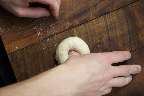 Someone forming a bagel with our best bagel recipe