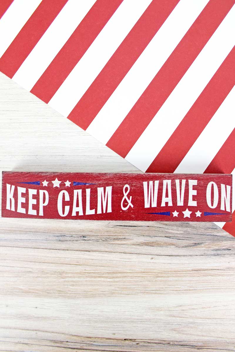 https://cdn.shopify.com/s/files/1/1250/2653/products/71573-wavediscontinued-15-x-725-keep-calm-wave-on-patriotic-wood-tabletop-block-852918_1600x.jpg?v=1684866836