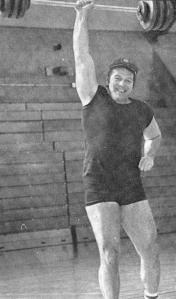 An Older Bruce Randall Lifting a Barbell above his Head