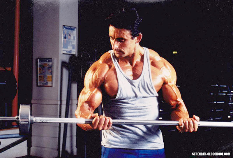 Bodybuilder Ray Nobile Performing Barbell Curls