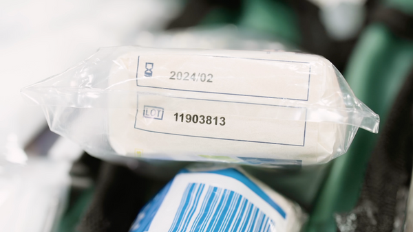 Workplace first aid kit item showing expiry date and lot number.