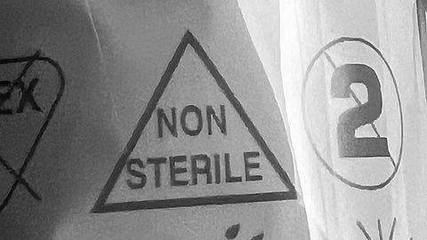 Photo of workplace first aid item showing a packaging non-sterile triangle symbol to indicate a first aid item has not been sterilised.