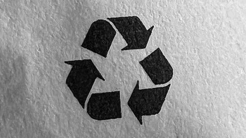 Photo of workplace first aid item showing a triangle with three black arrows symbol to indicate an item is recyclable or made from recycled material.