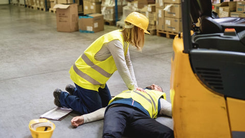 Australian first aider applying first aid skills to an incident at work.