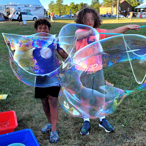 Children at Falcon Ridge Folk Festival making giant soap bubbles