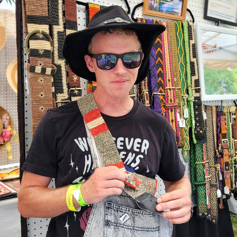 Man with grey coral snake model of Amazon guitar strap