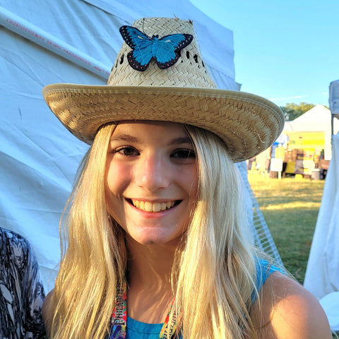 Woman with Amazon morpho butterfly hat pin at Philadelphia Folk Festival