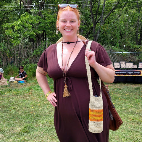 Woman with Amazon chambira palm fiber bottle carrier at Philadelphia Folk Festival