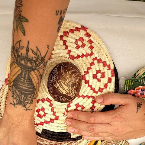 Woman with Amazon long-horned beetle calabash ornament and tattoo at Philadelphia Folk Festival