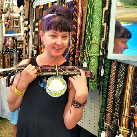 Woman displaying Amazon guitar strap bought at the Philadelphia Folk Festival