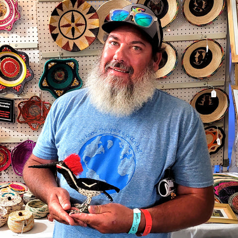 Lance displaying Amazon woodpecker ornament bought at the Philadelphia Folk Festival