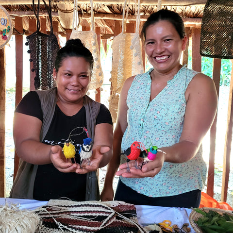 Puca Urquillo artisans displaying chambira bird ornaments made in cooperation with Amazon Ecology