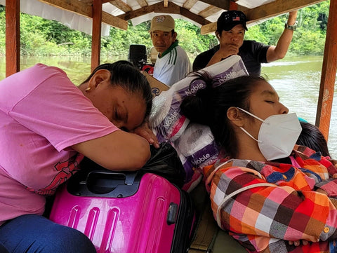Amazon Ecology team resting on boat going up the Yaguasyacu River