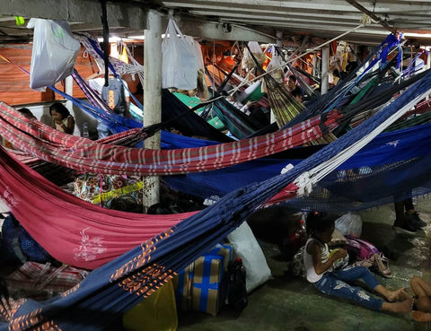 Passengers in hammocks on lancha down the Amazon River