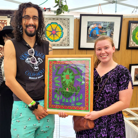 Yusef and partner with cambo frog painting done by Kukama artist from Padre Cocha