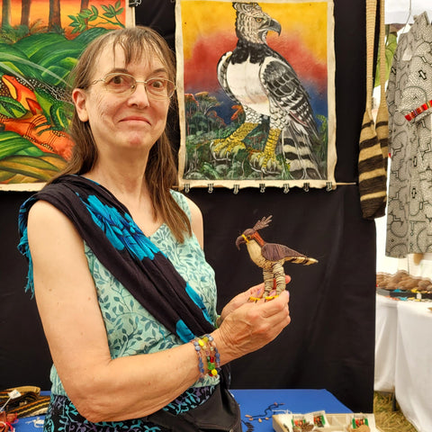Linda with an ornate hawk eagle ornament made by artisans from the Peruvian Amazon