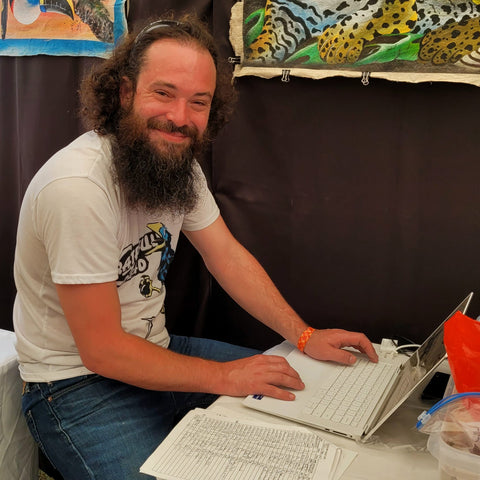 Amazon Ecology volunteer Padraic entering festival sales data
