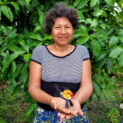 Amazonas artisan Leana Tuisima with chambira fish ornaments