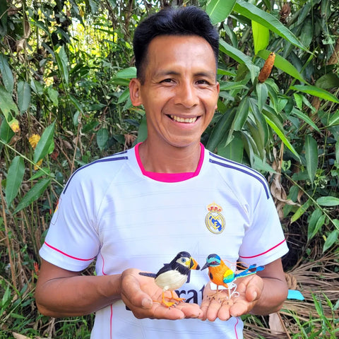 Bora artisan Misael Silva with woven bird ornaments