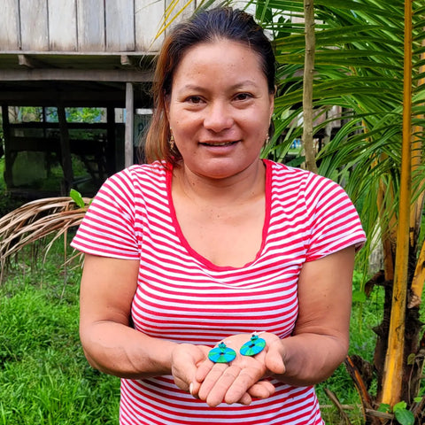 Estelita Loayza showing chambira earrings she made at Chino