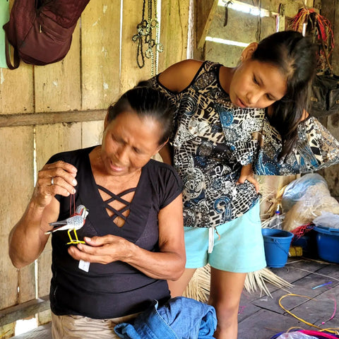 Santa Cruz artisans viewing chambira birds made by other Amazon Ecology partner artisans