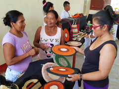Artisans practice selling chambira hot pads to a tourist. Photo by Campbell Plowden/Amazon Ecology