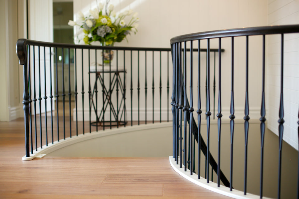 french inspired iron and wood railing