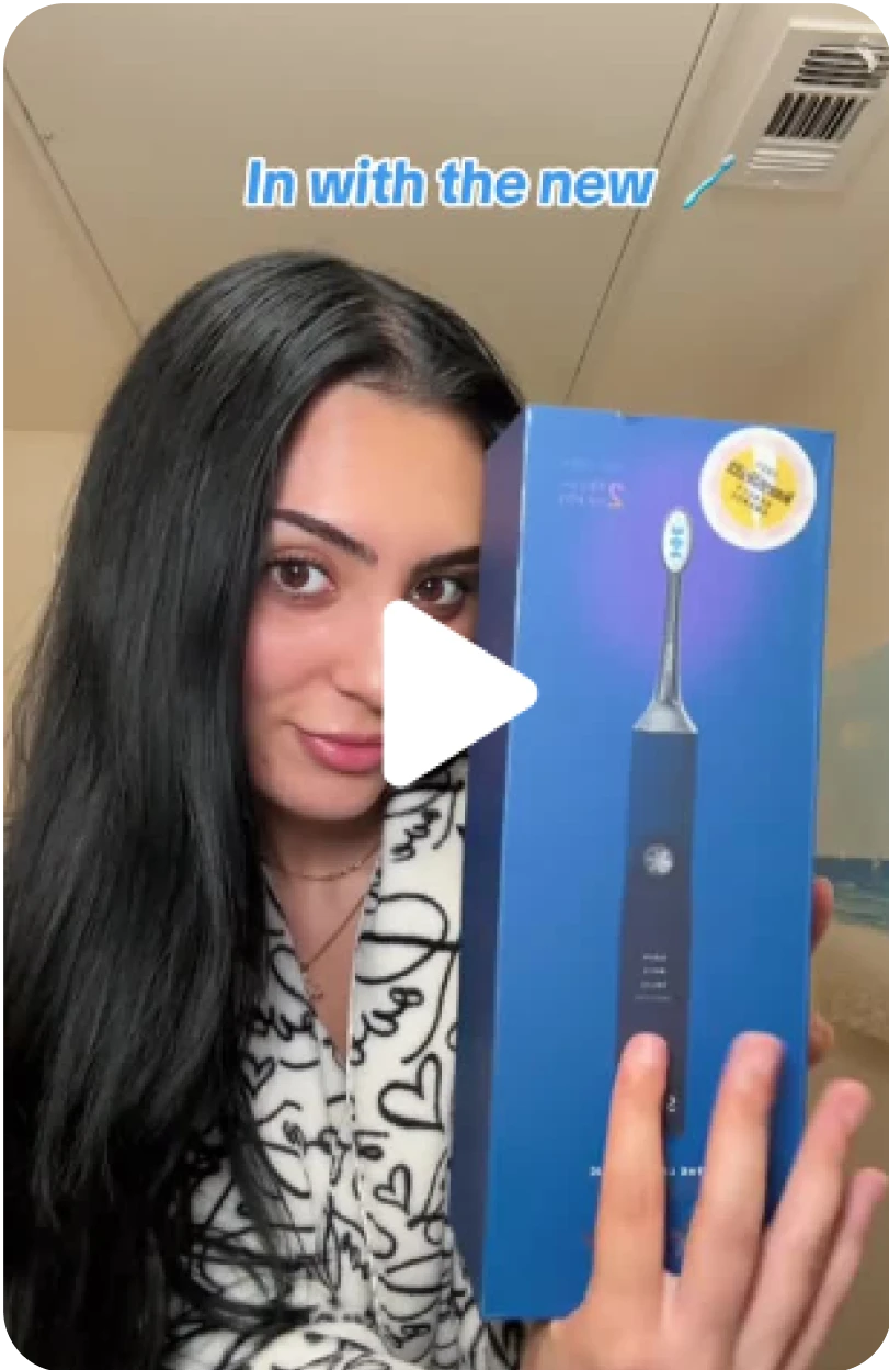 Person holding a new electric toothbrush in its packaging.