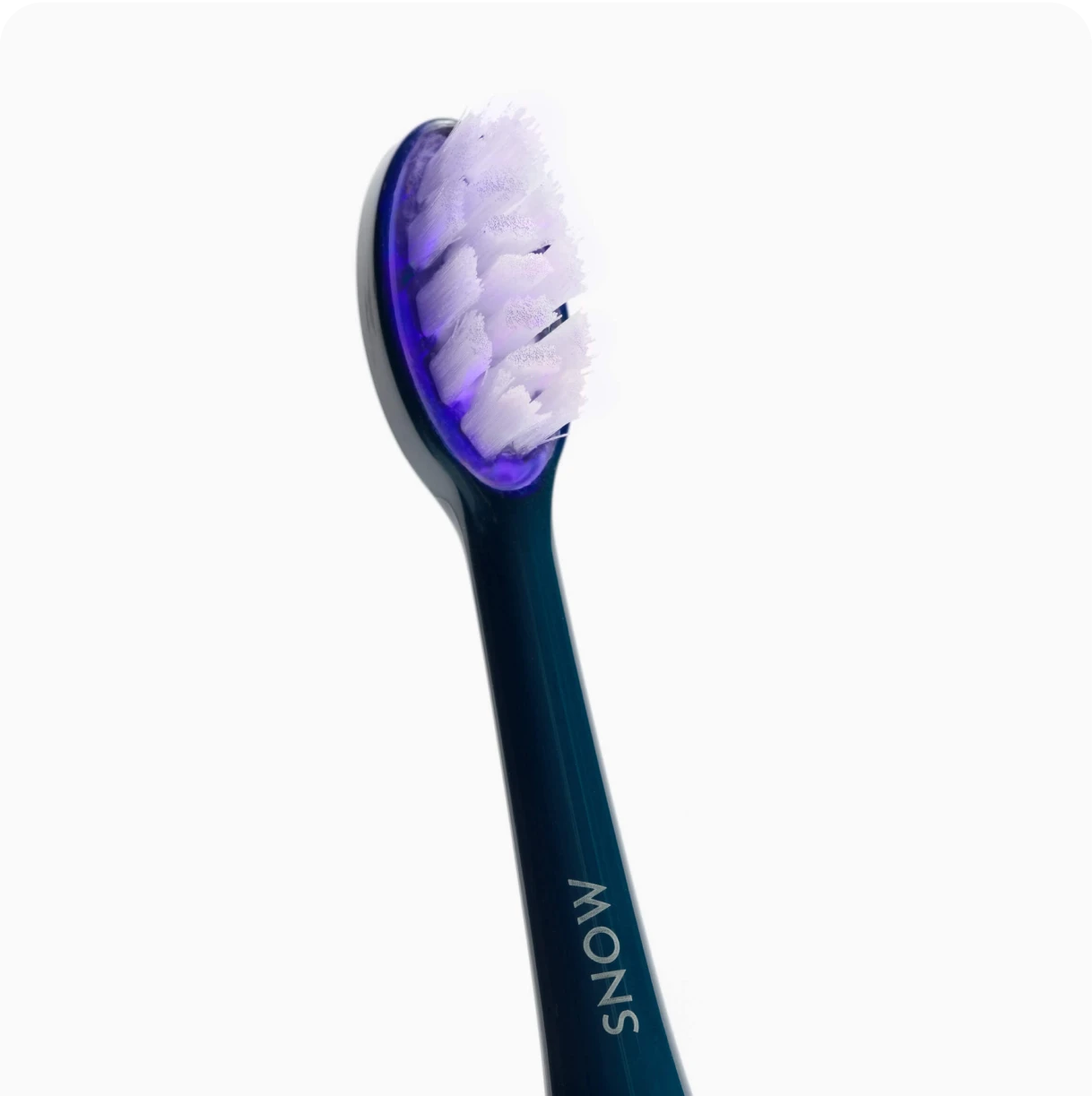 Close-up of a blue electric toothbrush head with white bristles.