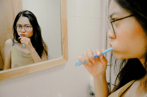 young girl brushing her teeth