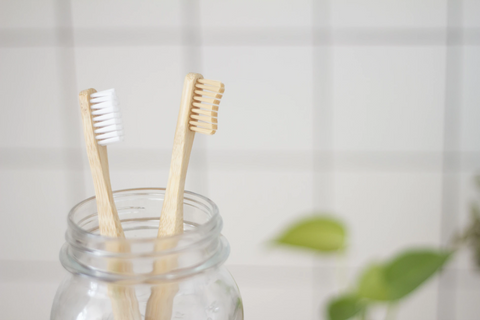 two wooden toothbrush in a jar