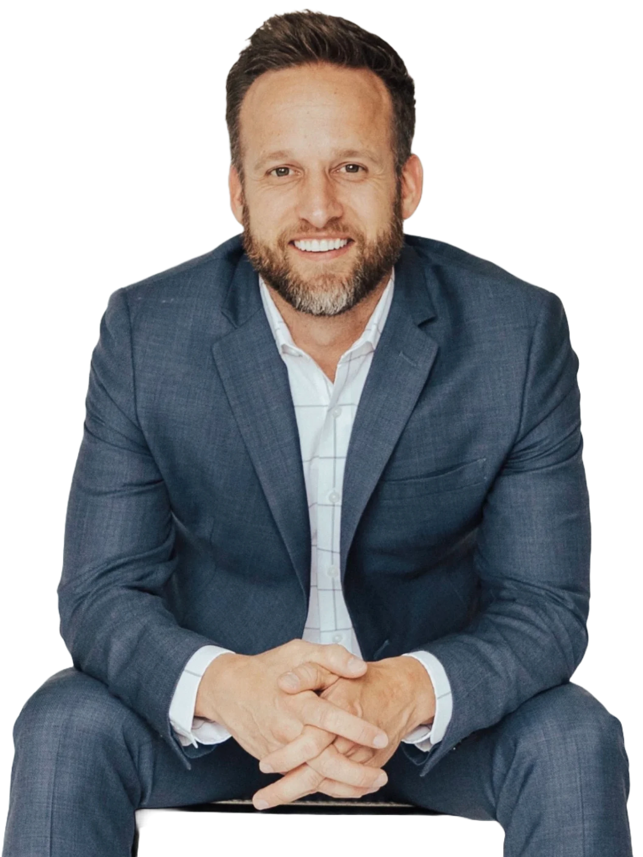 Man in a gray suit sitting and smiling.