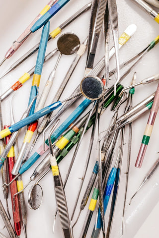 pile of dental tools on a table