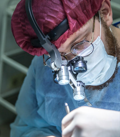 Surgeon performing surgery on a patient