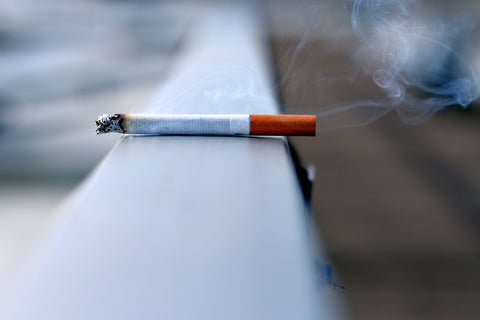 Cigarette resting on ledge