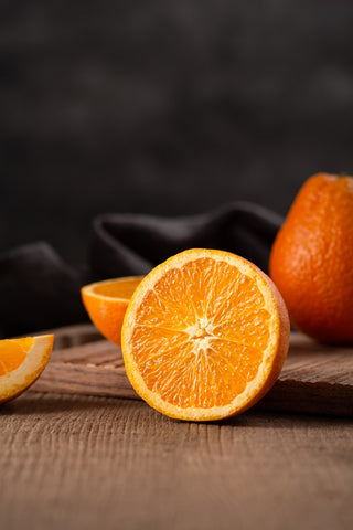 Orange cut in half on table