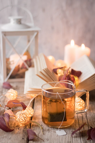 Glass of tea on a table with candles