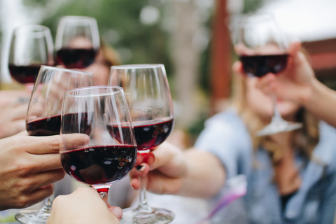 6 wine glasses held up in a toast