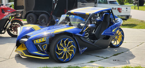 Polaris slingshot with powder coated blue and yellow wheels and bugatti headlights