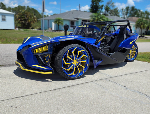Polaris Slingshot with color matched daytona yellow and stealth blue wheels