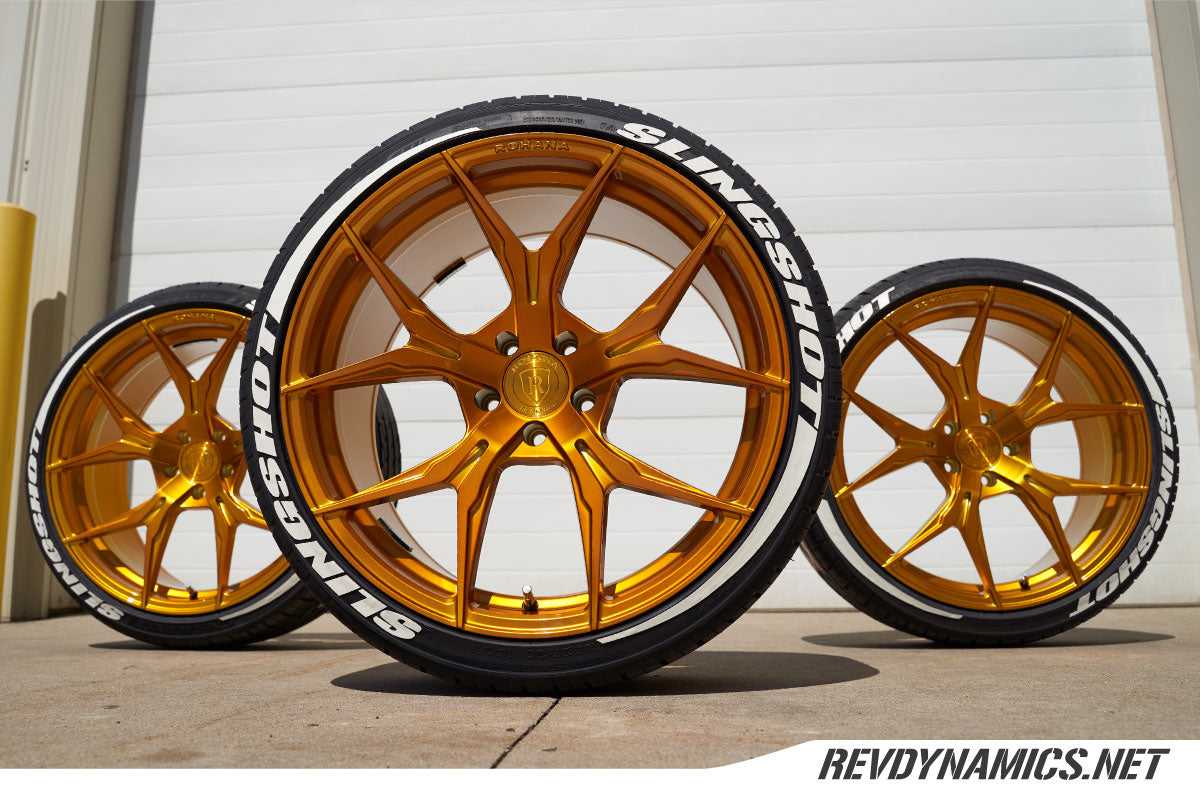 Gold wheel with white tire lettering