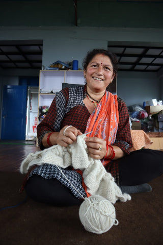 TerraKlay artisan knitting a white blanket made from 100% luxury Merino wool