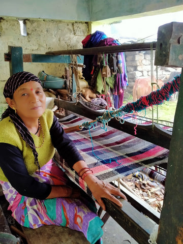 TerraKlay's artisan hand weaving a woolen thro blanket from home