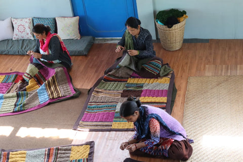 Woman knitting a patchwork blanket for TerraKlay